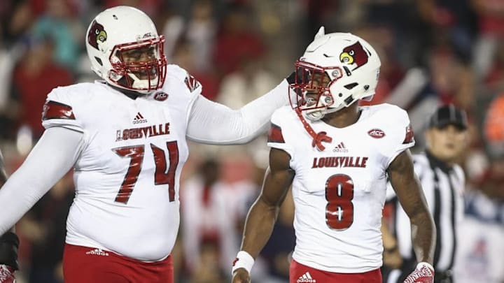 Nov 17, 2016; Houston, TX, USA; Louisville Cardinals offensive lineman Geron Christian (74) and quarterback Lamar Jackson (8) walk off the field after a play during the second quarter against the Houston Cougars at TDECU Stadium. Mandatory Credit: Troy Taormina-USA TODAY Sports