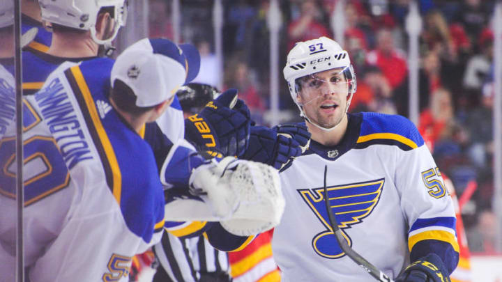 CALGARY, AB - DECEMBER 22: David Perron #57 (R) of the St Louis Blues celebrates after scoring against the Calgary Flames during an NHL game at Scotiabank Saddledome on December 22, 2018 in Calgary, Alberta, Canada. (Photo by Derek Leung/Getty Images)