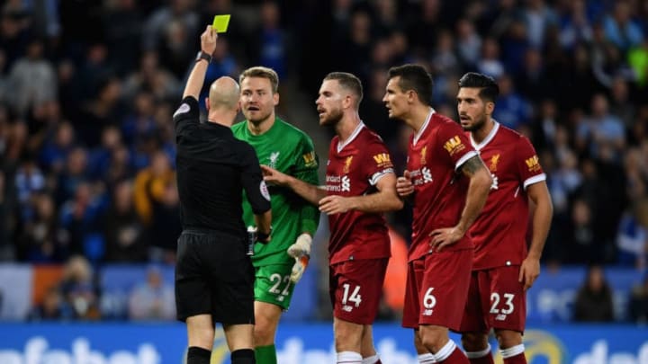 LEICESTER, ENGLAND - SEPTEMBER 23: Simon Mignolet of Liverpool is shown a yellow card by referee Anthony Taylor during the Premier League match between Leicester City and Liverpool at The King Power Stadium on September 23, 2017 in Leicester, England. (Photo by Michael Regan/Getty Images)