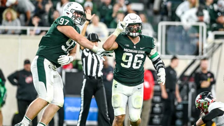 Michigan State’s Jacub Panasiuk, right, celebrates his sack with teammate Maverick Hansen during the third quarter in the game against Western Kentucky on Saturday, Oct. 2, 2021, at Spartan Stadium in East Lansing.211002 Msu Wku Fb 187a