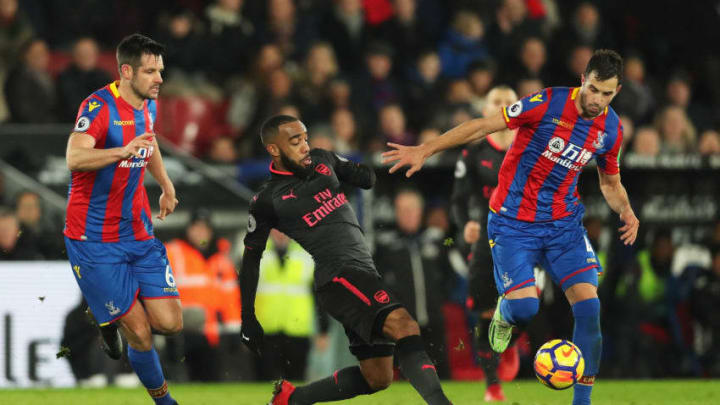 LONDON, ENGLAND - DECEMBER 28: Alexandre Lacazette of Arsenal (C) battles with Luka Milivojevic and Scott Dann of Crystal Palace during the Premier League match between Crystal Palace and Arsenal at Selhurst Park on December 28, 2017 in London, England. (Photo by Dan Istitene/Getty Images)