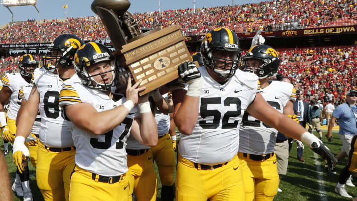 AMES, IA – SEPTEMBER 9: Defensive back Brandon Snyder #37 of the Iowa Hawkeyes, and offensive lineman Boone Myers #52 of the Iowa Hawkeyes celebrate by carrying the Cy-Hawk Trophy to their fans after defeating the Iowa State Cyclones 44-41 in overtime at Jack Trice Stadium on September 9, 2017 in Ames, Iowa. The Iowa Hawkeyes won 44-41 over the Iowa State Cyclones. (Photo by David Purdy/Getty Images)