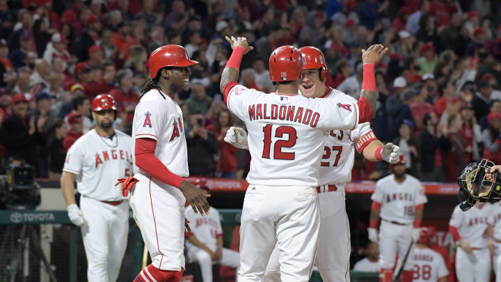 May 17, 2017; Anaheim, CA, USA; Los Angeles Angels center fielder Mike Trout (27) celebrates with teammates Cameron Maybin (9) and Martin Maldonado (12) after hitting a three-run home run in the sixth inning against the Chicago White Sox during a MLB baseball game at Angel Stadium of Anaheim. Mandatory Credit: Kirby Lee-USA TODAY Sports