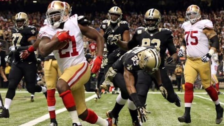 Nov 9, 2014; New Orleans, LA, USA; San Francisco 49ers running back Frank Gore (21) carries the ball to score a touchdown against the New Orleans Saints in the first quarter at Mercedes-Benz Superdome. Mandatory Credit: Chuck Cook-USA TODAY Sports