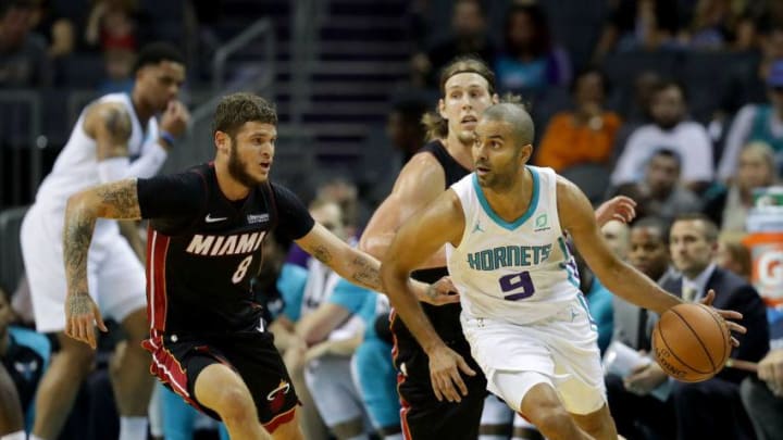 CHARLOTTE, NC - OCTOBER 02: Tony Parker #9 of the Charlotte Hornets looks to pass against Tyler Johnson #8 of the Miami Heat during their game at Spectrum Center on October 2, 2018 in Charlotte, North Carolina. NOTE TO USER: User expressly acknowledges and agrees that, by downloading and or using this photograph, User is consenting to the terms and conditions of the Getty Images License Agreement. (Photo by Streeter Lecka/Getty Images)