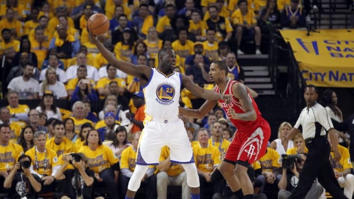 Apr 18, 2016; Oakland, CA, USA; Golden State Warriors forward Draymond Green (23) holds the ball away from Houston Rockets forward Trevor Ariza (1) in the first quarter in game two of the first round of the NBA Playoffs at Oracle Arena. Mandatory Credit: Cary Edmondson-USA TODAY Sports