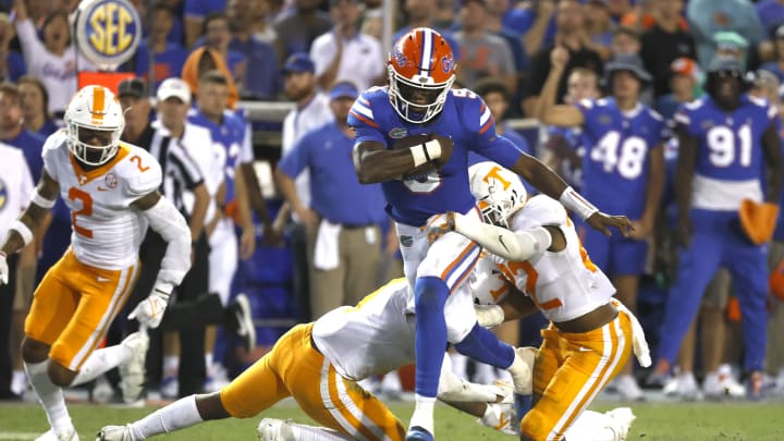 Sep 25, 2021; Gainesville, Florida, USA; Florida Gators quarterback Emory Jones (5) runs with the ball as Tennessee Volunteers defensive back Jaylen McCollough (22) defends during the third quarter at Ben Hill Griffin Stadium. Mandatory Credit: Kim Klement-USA TODAY Sports