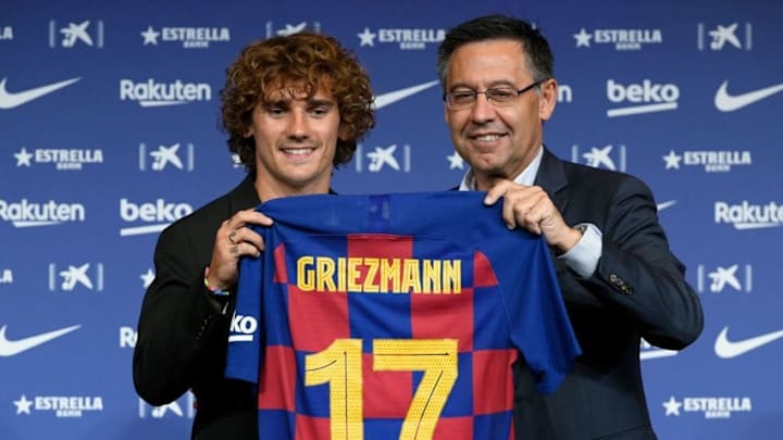 Barcelona's new French forward Antoine Griezmann poses with his new jersey next to the football club's president Josep Maria Bartomeu (R) during his official presentation at the Camp Nou stadium in Barcelona on July 14, 2019. (Photo by LLUIS GENE / AFP) (Photo credit should read LLUIS GENE/AFP via Getty Images)