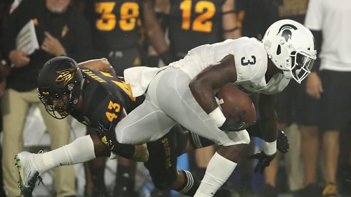 TEMPE, AZ – SEPTEMBER 08: Running back LJ Scott #3 of the Michigan State Spartans rushes the football past safety Jalen Harvey #43 of the Arizona State Sun Devils during the college football game at Sun Devil Stadium on September 8, 2018 in Tempe, Arizona. The Sun Devils defeated the Spartans 16-13. (Photo by Christian Petersen/Getty Images)