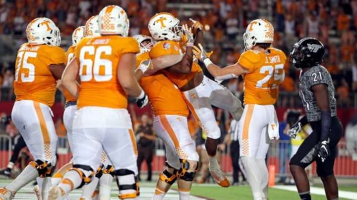 Sep 10, 2016; Bristol, TN, USA; Tennessee Volunteers running back John Kelly (4) celebrates scoring a touchdown against the Virginia Tech Hokies during the fourth quarter at Bristol Motor Speedway. Mandatory Credit: Peter Casey-USA TODAY Sports