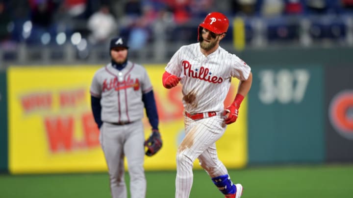 PHILADELPHIA, PA - MARCH 31: Bryce Harper #3 of the Philadelphia Phillies rounds the bases in front of Josh Donaldson #20 of the Atlanta Braves after hitting a home run in the seventh inning at Citizens Bank Park on March 31, 2019 in Philadelphia, Pennsylvania. (Photo by Drew Hallowell/Getty Images)