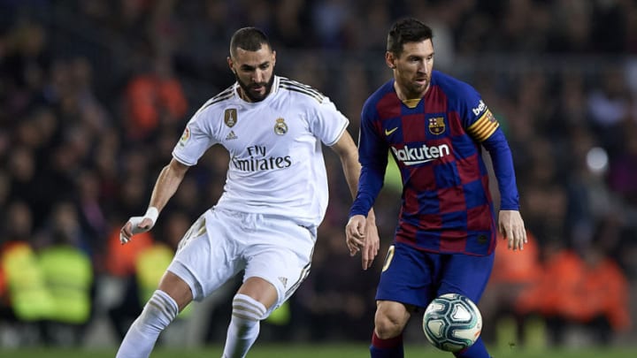 Lionel Messi (R) of Barcelona competes for the ball with Karim Benzema of Real Madrid. (Photo by Pablo Morano/MB Media/Getty Images)