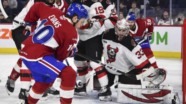 LAVAL, QC - MARCH 27: Goaltender Cam Johnson #33 of the Binghamton Devils protects his net from Jake Evans #10 of the Laval Rocket during the AHL game at Place Bell on March 27, 2019 in Laval, Quebec, Canada. The Binghamton Devils defeated the Laval Rocket 5-1. (Photo by Minas Panagiotakis/Getty Images)