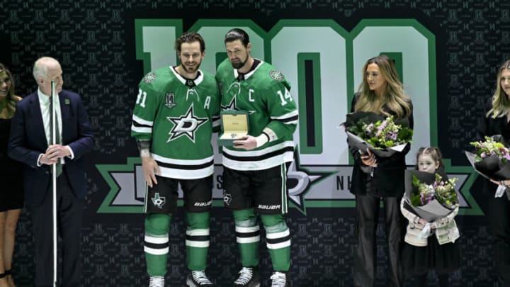 Mar 4, 2023; Dallas, Texas, USA; Dallas Stars center Tyler Seguin (91) presents left wing Jamie Benn (14) with a silver watch during a ceremony in recognition of Benn playing in 1000 career NHL games before the start of the game between the Dallas Stars and the Colorado Avalanche at the American Airlines Center. Mandatory Credit: Jerome Miron-USA TODAY Sports