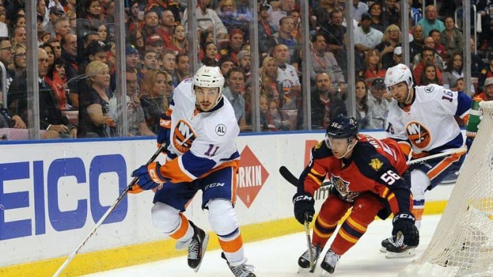 Apr 22, 2016; Sunrise, FL, USA; New York Islanders center Shane Prince (11) works the puck as Florida Panthers defenseman Michael Matheson (56) gives chase during first period action in game five of the first round of the 2016 Stanley Cup Playoffs at BB&T Center. Mandatory Credit: Robert Duyos-USA TODAY Sports