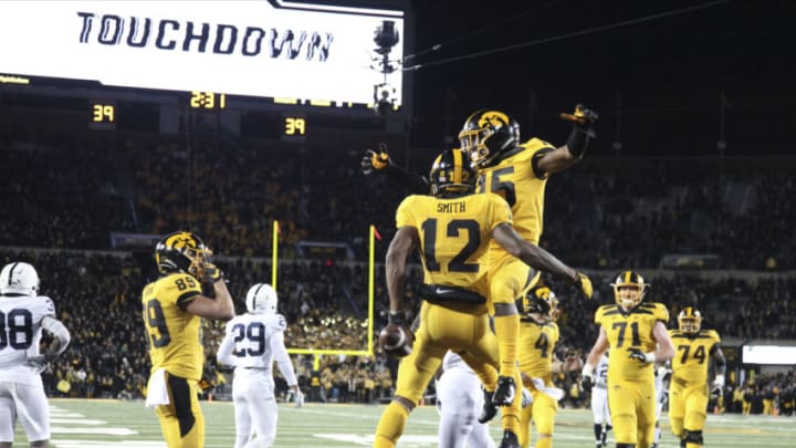 IOWA CITY, IOWA - OCTOBER 12: Wide receiver Brandon Smith #12 and rung back Tyler Goodsen #15 of the Iowa Hawkeyes celebrate a touchdown during the second half against the Penn State Nittany Lions on October 12, 2019 at Kinnick Stadium in Iowa City, Iowa. (Photo by Matthew Holst/Getty Images)