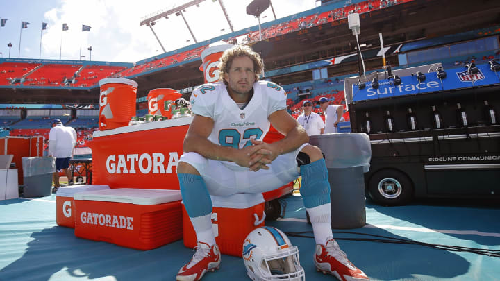 MIAMI GARDENS, FL – DECEMBER 28: Long snapper John Denney #92 of the Miami Dolphins sits on a cooler during pregame workouts before the Dolphins met the New York Jets in a game at Sun Life Stadium on December 28, 2014 in Miami Gardens, Florida. (Photo by Chris Trotman/Getty Images)