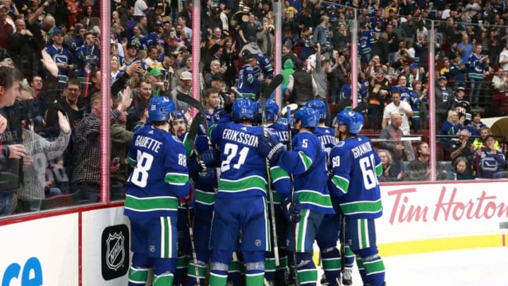 VANCOUVER, BC - OCTOBER 20: Vancouver Canuck players gather around Bo Horvat #53 of the Vancouver Canucks after he scored the overtime winning goal during their NHL game against the Boston Bruins at Rogers Arena October 20, 2018 in Vancouver, British Columbia, Canada. Vancouver won 2-1 in overtime. (Photo by Jeff Vinnick/NHLI via Getty Images)