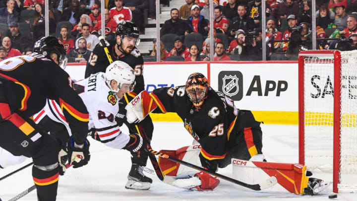 CALGARY, CANADA - JANUARY 26: Sam Lafferty #24 of the Chicago Blackhawks takes a shot on Jacob Markstrom #25 of the Calgary Flames during the second period of an NHL game at Scotiabank Saddledome on January 26, 2023 in Calgary, Alberta, Canada. (Photo by Derek Leung/Getty Images)