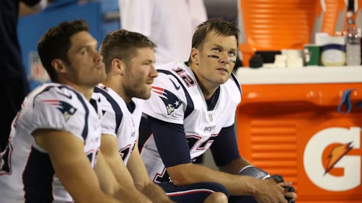 CHARLOTTE, NC - AUGUST 24: Tom Brady #12 and teammates Julian Edelman #11 and Chris Hogan #15 of the New England Patriots talk on the bench in the third quarter against the Carolina Panthers during their game at Bank of America Stadium on August 24, 2018 in Charlotte, North Carolina. (Photo by Streeter Lecka/Getty Images) CHARLOTTE, NC - AUGUST 24: Tom Brady #12 and teammates Julian Edelman #11 and Chris Hogan #15 of the New England Patriots talk on the bench in the third quarter against the Carolina Panthers during their game at Bank of America Stadium on August 24, 2018 in Charlotte, North Carolina. (Photo by Streeter Lecka/Getty Images)