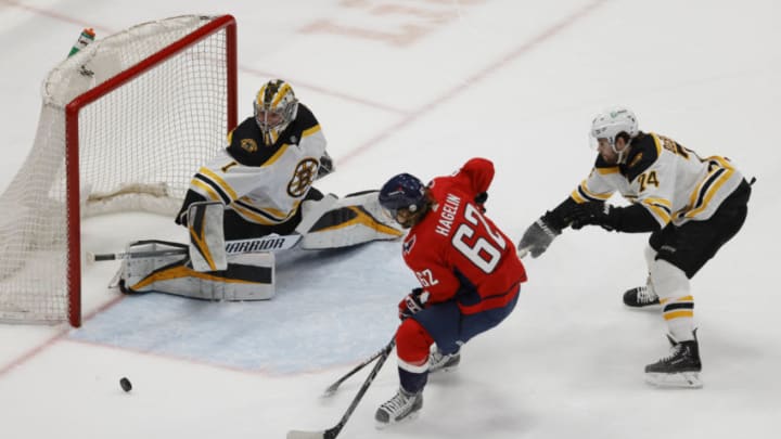 May 11, 2021; Washington, District of Columbia, USA; Boston Bruins goaltender Jeremy Swayman (1) makes a save on Washington Capitals left wing Carl Hagelin (62) as Bruins left wing Jake DeBrusk (74) defends in the first period at Capital One Arena. Mandatory Credit: Geoff Burke-USA TODAY Sports
