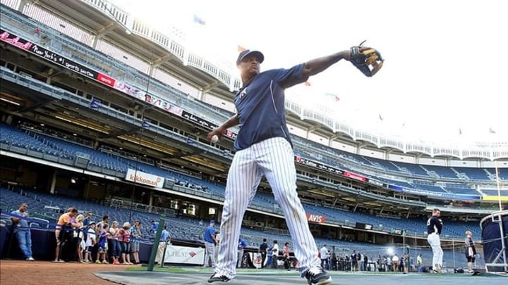 May 30, 2013; Bronx, NY, USA; New York Yankees second baseman Robinson Cano (24) plays catch on the field during batting practice before the start of a game against the New York Mets at Yankees Stadium. Mandatory Credit: Brad Penner-USA TODAY Sports