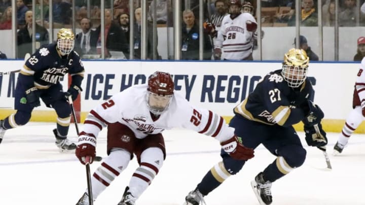 MANCHESTER, NH - MARCH 30: UMASS Minutemen forward Brett Boeing (22) fends off Notre Dame Fighting Irish defenseman Bobby Nardella (27) during the Northeast Regional final between the UMASS Minutemen and the Notre Dame Fighting Irish on March 30, 2019, at SNHU Arena in Manchester, NH. (Photo by Fred Kfoury III/Icon Sportswire via Getty Images)