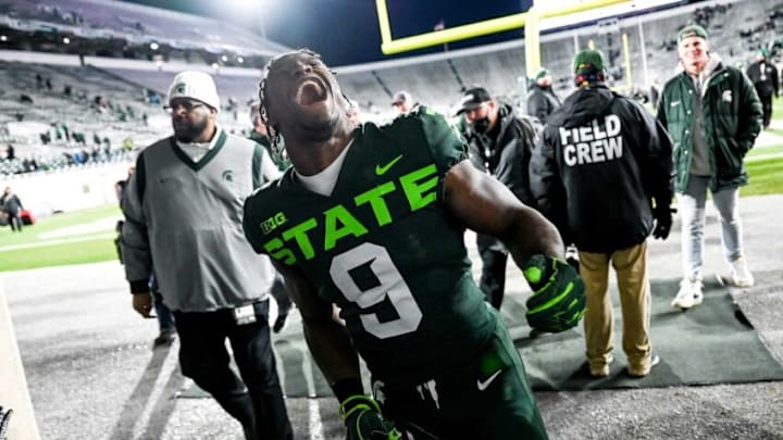 Michigan State's Kenneth Walker III celebrates with fans after beating Maryland on Saturday, Nov. 13, 2021, at Spartan Stadium in East Lansing.211113 Msu Maryland 210a