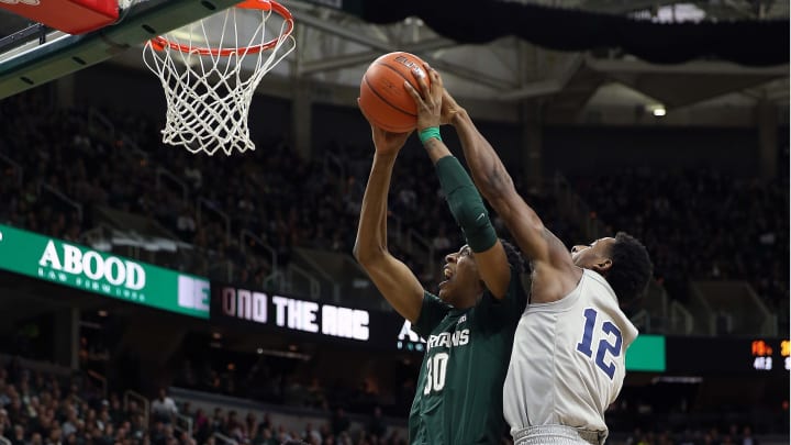 Feb 4, 2020; East Lansing, Michigan, USA; Michigan State Spartans forward Marcus Bingham Jr. (30) against Penn State Nittany Lions forward Mike Watkins (24) and Penn State Nittany Lions guard Izaiah Brockington (12) during the second half of a game at the Breslin Center. Mandatory Credit: Mike Carter-USA TODAY Sports