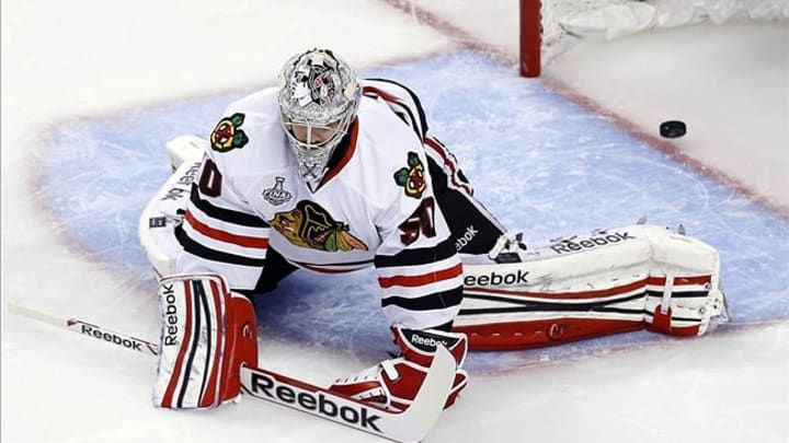 Jun 19, 2013; Boston, MA, USA; Chicago Blackhawks goalie Corey Crawford (50) reacts after giving up a goal to Boston Bruins center Patrice Bergeron (not pictured) during the third period in game four of the 2013 Stanley Cup Final at TD Garden. Mandatory Credit: Greg M. Cooper-USA TODAY Sports