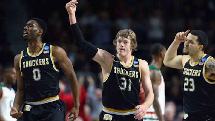 PROVIDENCE, RI - MARCH 19: (L-R) Rashard Kelly #0 of the Wichita State Shockers, Ron Baker #31, and Fred VanVleet #23 react in the second half against the Miami Hurricanes during the second round of the 2016 NCAA Men's Basketball Tournament at Dunkin' Donuts Center on March 19, 2016 in Providence, Rhode Island. (Photo by Jim Rogash/Getty Images)