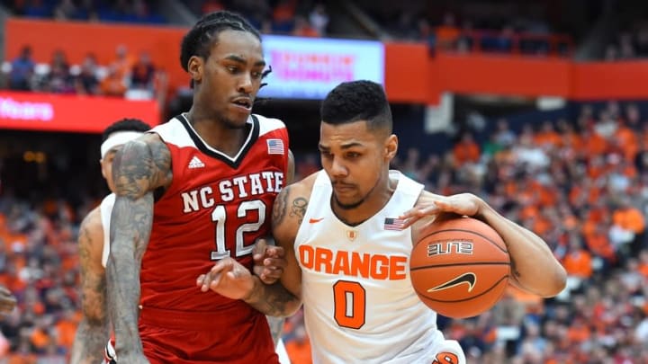 Feb 27, 2016; Syracuse, NY, USA; Syracuse Orange forward Michael Gbinije (0) drives to the basket against the defense of North Carolina State Wolfpack guard Anthony Barber (12) during the second half at the Carrier Dome. Syracuse defeated North Carolina State 75-66. Mandatory Credit: Rich Barnes-USA TODAY Sports