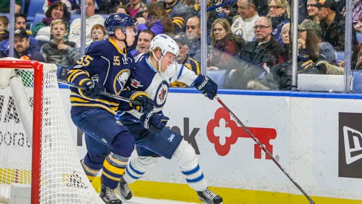 BUFFALO, NY - JANUARY 7: Winnipeg Jets Right Wing Patrik Laine (29) tries to control puck as Buffalo Sabres Defenseman Rasmus Ristolainen (55) defends during the New Winnipeg Jets and Buffalo Sabres NHL game on January 7, 2017, at KeyBank Center in Buffalo, NY. (Photo by John Crouch/Icon Sportswire via Getty Images)