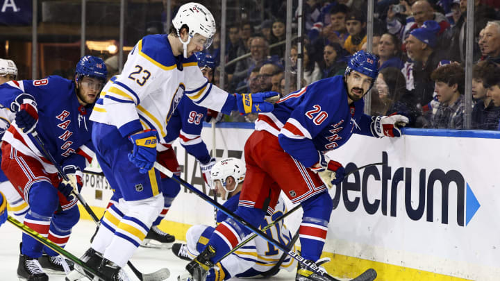 Mar 27, 2022; New York, New York, USA; New York Rangers left wing Chris Kreider (20) plays for the puck against Buffalo Sabres defenseman Mattias Samuelsson (23) during the second period at Madison Square Garden. Mandatory Credit: Jessica Alcheh-USA TODAY Sports