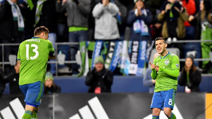 SEATTLE, WASHINGTON - MARCH 02: Victor Rodriguez #8, and Jordan Morris #13 of Seattle Sounders celebrate after scoring a goal against the FC Cincinnati at CenturyLink Field on March 02, 2019 in Seattle, Washington.(Photo by Alika Jenner/Getty Images)