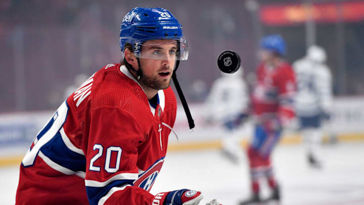 Sep 27, 2021; Montreal, Quebec, CAN; Montreal Canadiens defenseman Chris Wideman (20) flips a puck to a young fan during the warmup period before a game against the Toronto Maple Leafs at the Bell Centre. Mandatory Credit: Eric Bolte-USA TODAY Sports