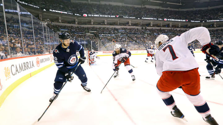 WINNIPEG, MB - OCTOBER 17: Joel Armia #40 of the Winnipeg Jets plays the puck as David Savard #58 and Jack Johnson #7 of the Columbus Blue Jackets defend during first period action at the Bell MTS Place on October 17, 2017 in Winnipeg, Manitoba, Canada. (Photo by Darcy Finley/NHLI via Getty Images)