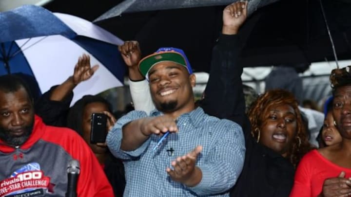 Feb 4, 2015; Glen Saint Mary, FL, USA; Ce Ce Jefferson signs with the University of Florida at his home near Baker County High School as his parents Leo and Annette Jefferson look on. Mandatory Credit: Richard Dole-USA TODAY Sports