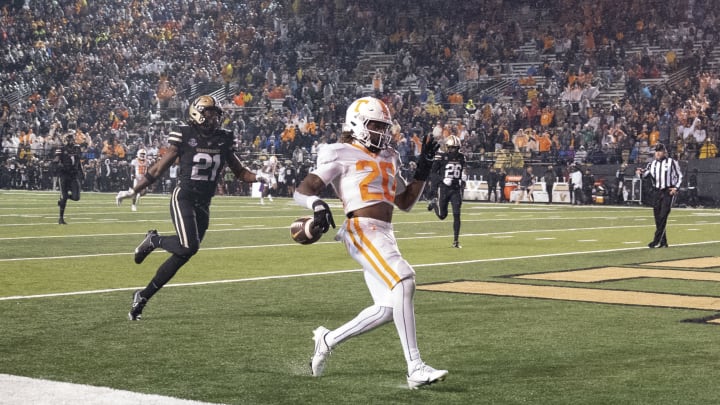 Nov 26, 2022; Nashville, Tennessee, USA;Tennessee Volunteers running back Jaylen Wright (20) runs into the end zone for a touchdown against Vanderbilt Commodores safety Maxwell Worship (21) during the third quarter at FirstBank Stadium. Mandatory Credit: George Walker IV – USA TODAY Sports