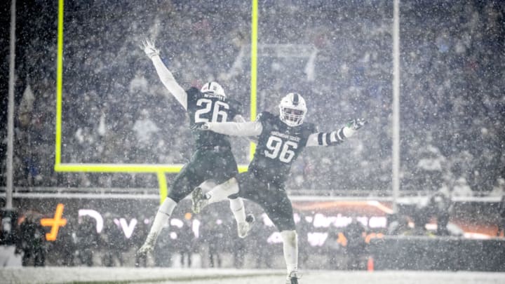 EAST LANSING, MICHIGAN - NOVEMBER 27: Brandon Wright #26 and Jacub Panasiuk #96 of the Michigan State Spartans celebrate against the Penn State Nittany Lions during the fourth quarter at Spartan Stadium on November 27, 2021 in East Lansing, Michigan. (Photo by Nic Antaya/Getty Images)