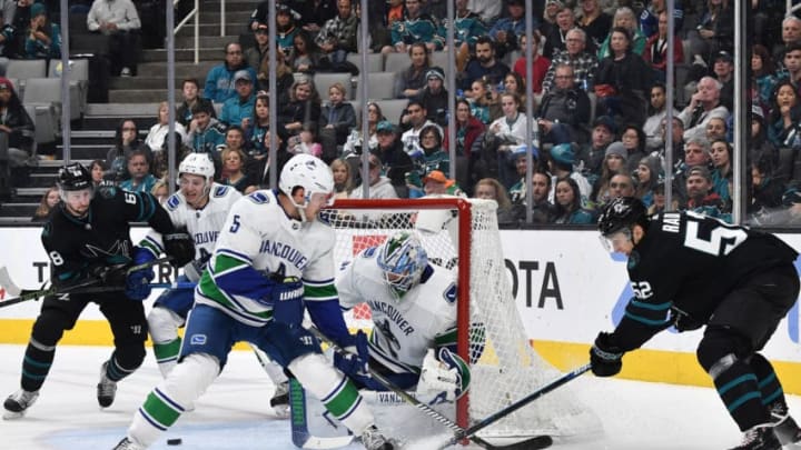 SAN JOSE, CA - NOVEMBER 23: (R-L) Lukas Radil #52 of the San Jose Sharks takes a shot on goal against Anders Nilsson #32 of the Vancouver Canucks at SAP Center on November 23, 2018 in San Jose, California (Photo by Brandon Magnus/NHLI via Getty Images)