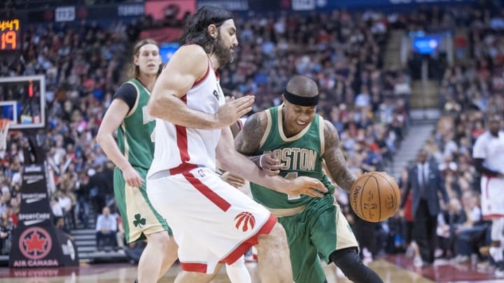 Mar 18, 2016; Toronto, Ontario, CAN; Boston Celtics guard Isaiah Thomas (4) dribbles against Toronto Raptors forward Luis Scola (4) in the third quarter at Air Canada Centre. Raptors beat Celtics 105 - 91. Mandatory Credit: Peter Llewellyn-USA TODAY Sports