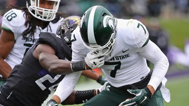 EVANSTON, IL – OCTOBER 28: Cody White #7 of the Michigan State Spartans fumbles the ball as he’s hit by Montre Hartage #24 of the Northwestern Wildcats at Ryan Field on October 28, 2017 in Evanston, Illinois. (Photo by Jonathan Daniel/Getty Images)