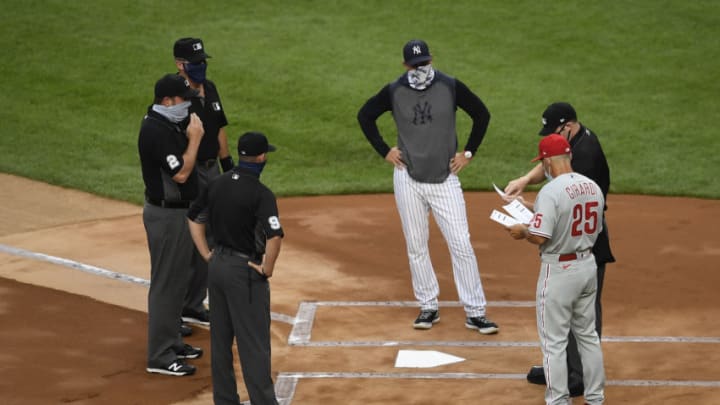 NEW YORK, NEW YORK - AUGUST 03: Manager Aaron Boone #17 of the New York Yankees meets with Manager Joe Girardi #25 of the Philadelphia Phillies and the umpires before the first inning at Yankee Stadium on August 03, 2020 in the Bronx borough of New York City. (Photo by Sarah Stier/Getty Images)