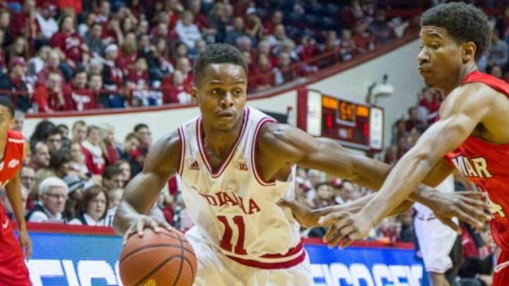 Nov 22, 2014; Bloomington, IN, USA; Indiana Hoosiers guard Yogi Ferrell (11) dribbles the ball around Lamar Cardinals guard Quan Jones (24) in the first half of the game at Assembly Hall. Indiana Hoosiers beat Lamar Cardinals by the score of 85-72. Mandatory Credit: Trevor Ruszkowski-USA TODAY Sports