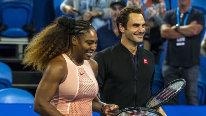 TOPSHOT - Roger Federer of Switzerland (R) stands alongside Serena Willams of the US (L) following their mixed mixed doubles match in their sixth session on day four of the Hopman Cup tennis tournament in Perth January 1, 2019. (Photo by TONY ASHBY / AFP) / -- IMAGE RESTRICTED TO EDITORIAL USE - STRICTLY NO COMMERCIAL USE -- (Photo credit should read TONY ASHBY/AFP/Getty Images)