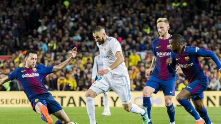 BARCELONA, SPAIN - MAY 06: Karim Benzema (2nd from L) of Real Madrid vies for the ball with Sergio Busquets Burgos (L) of FC Barcelona during the La Liga match between Barcelona and Real Madrid at Camp Nou on May 6, 2018 in Barcelona, Spain. (Photo by Power Sport Images/Getty Images)
