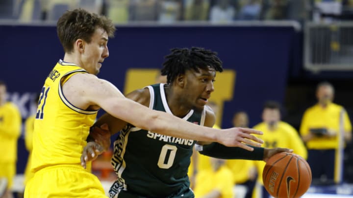 Mar 4, 2021; Ann Arbor, Michigan, USA; Michigan State Spartans forward Aaron Henry (0) dribbles while pressured by Michigan Wolverines guard Franz Wagner (21) in the second half at Crisler Center. Mandatory Credit: Rick Osentoski-USA TODAY Sports