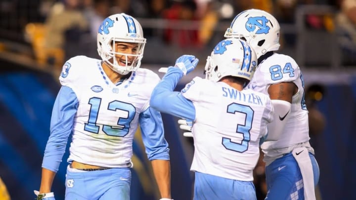 Oct 29, 2015; Pittsburgh, PA, USA; North Carolina Tar Heels wide receiver Mack Hollins (13) reacts after scoring on a thirty-two yard touchdown pass with teammates wide receiver Ryan Switzer (3) and wide receiver Bug Howard (84) against the Pittsburgh Panthers during the second quarter at Heinz Field. Mandatory Credit: Charles LeClaire-USA TODAY Sports