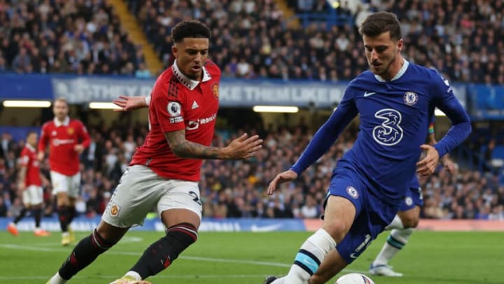 Chelsea's English midfielder Mason Mount (R) vies with Manchester United's English striker Jadon Sancho (L) during the English Premier League football match between Chelsea and Manchester United at Stamford Bridge in London on October 22, 2022. - RESTRICTED TO EDITORIAL USE. No use with unauthorized audio, video, data, fixture lists, club/league logos or 'live' services. Online in-match use limited to 120 images. An additional 40 images may be used in extra time. No video emulation. Social media in-match use limited to 120 images. An additional 40 images may be used in extra time. No use in betting publications, games or single club/league/player publications. (Photo by ADRIAN DENNIS / AFP) / RESTRICTED TO EDITORIAL USE. No use with unauthorized audio, video, data, fixture lists, club/league logos or 'live' services. Online in-match use limited to 120 images. An additional 40 images may be used in extra time. No video emulation. Social media in-match use limited to 120 images. An additional 40 images may be used in extra time. No use in betting publications, games or single club/league/player publications. / RESTRICTED TO EDITORIAL USE. No use with unauthorized audio, video, data, fixture lists, club/league logos or 'live' services. Online in-match use limited to 120 images. An additional 40 images may be used in extra time. No video emulation. Social media in-match use limited to 120 images. An additional 40 images may be used in extra time. No use in betting publications, games or single club/league/player publications. (Photo by ADRIAN DENNIS/AFP via Getty Images)